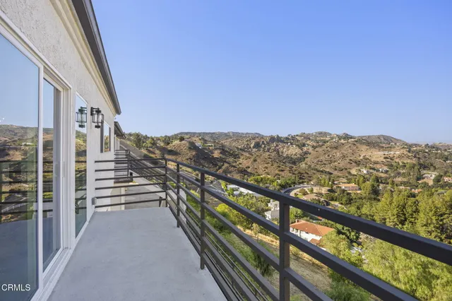an empty room with wooden floor and entrance