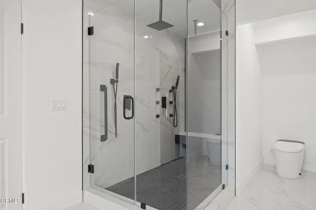 a bathroom with double vanity sink toilet and shower