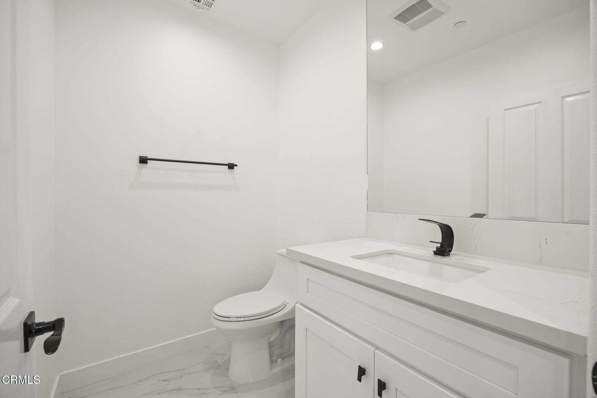 40 Saddlebow Road Bell Canyon, CA 91307 - Photo 57 of 70 a bathroom with a sink a toilet and mirror