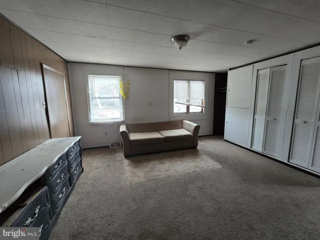 a spacious bedroom with a bed and a window