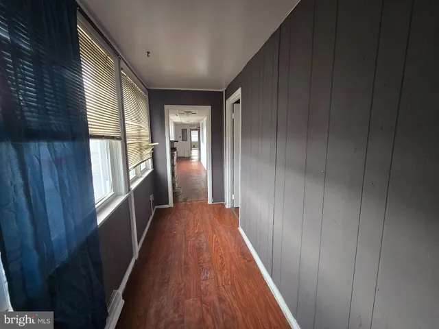 a view of hallway with wooden floor