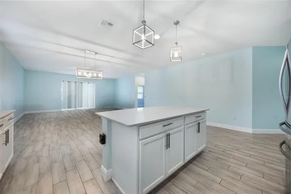 a view of a kitchen counter space a sink and wooden floor