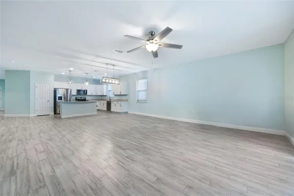 a view of a livingroom with furniture and a ceiling fan