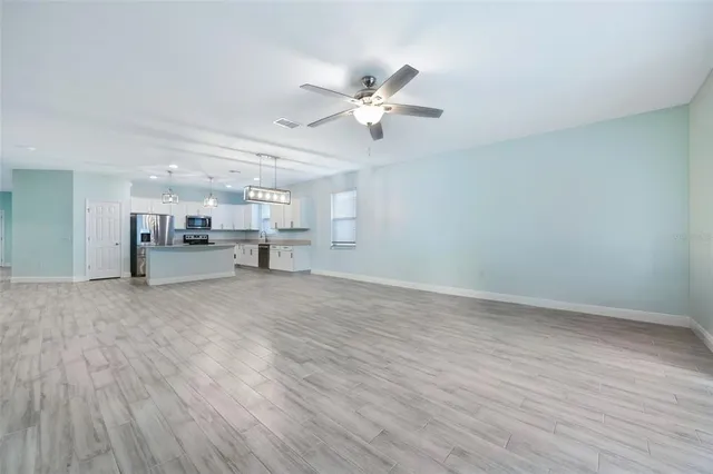 a view of a livingroom with furniture and a ceiling fan