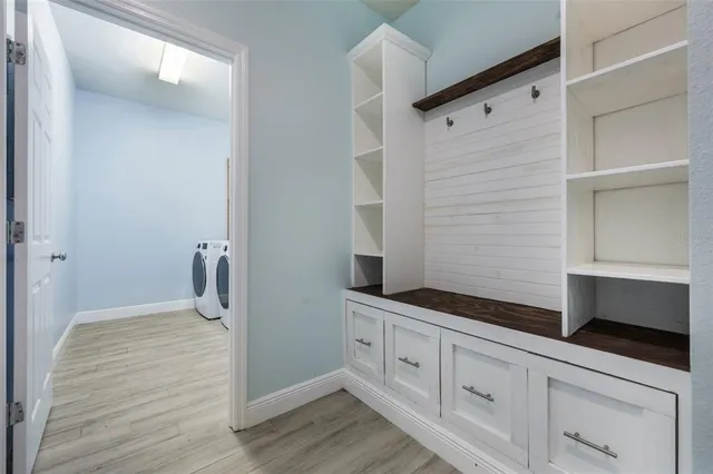 a hallway with sink and mirror