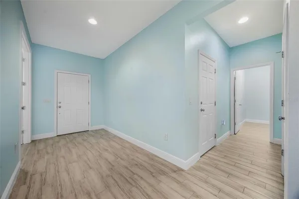 a view of hallway with wooden floor