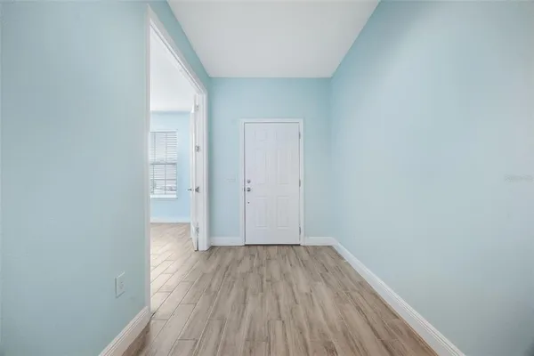 a view of a room with wooden floor