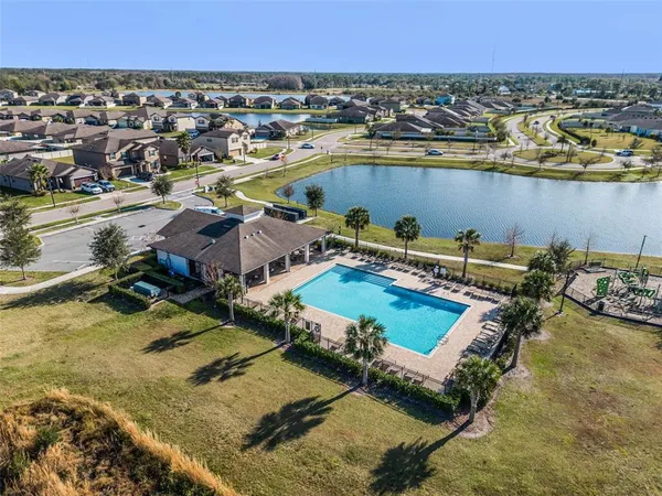 an aerial view of a house with a lake view
