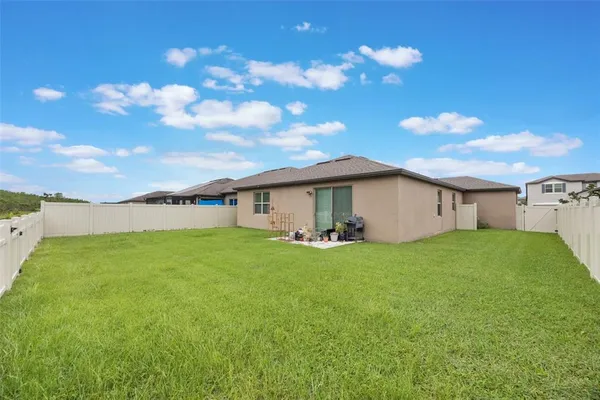 a view of a backyard with plants and a big yard
