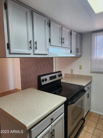 a kitchen with granite countertop a stove and a sink