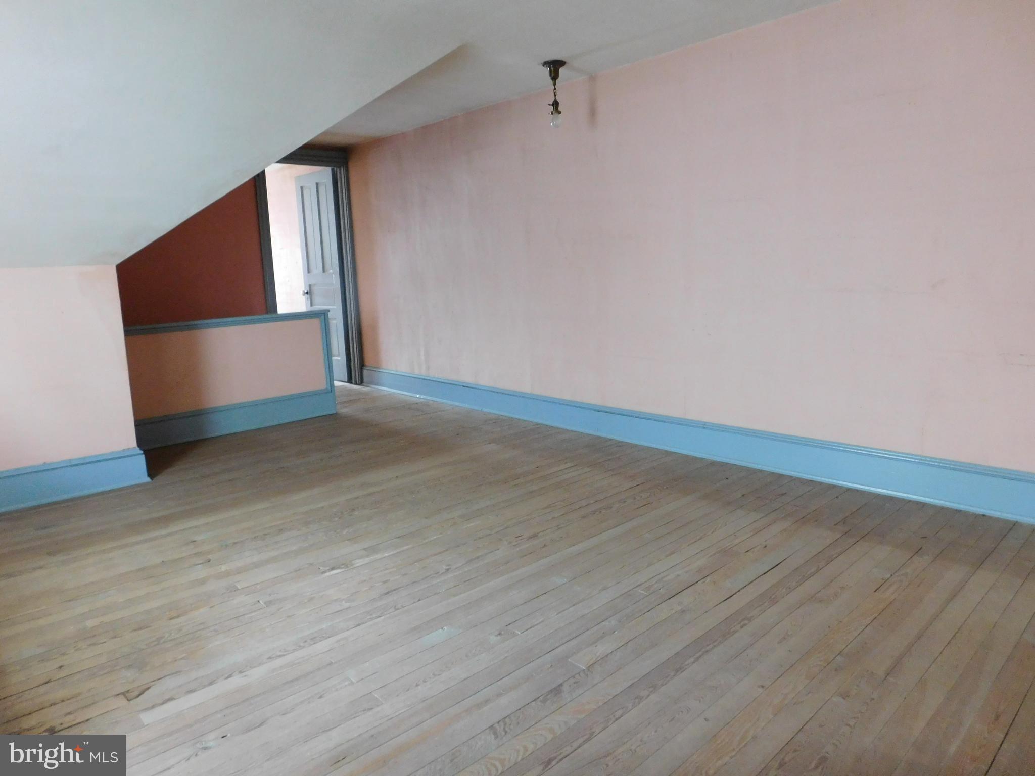 103 East Amidon Street Summit Hill, PA 18250 - Photo 15 of 16 a view of an empty room with wooden floor and a window