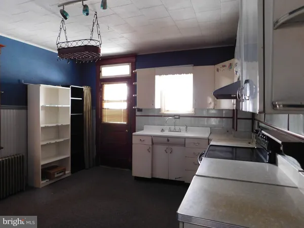 a kitchen with a sink stove and cabinets
