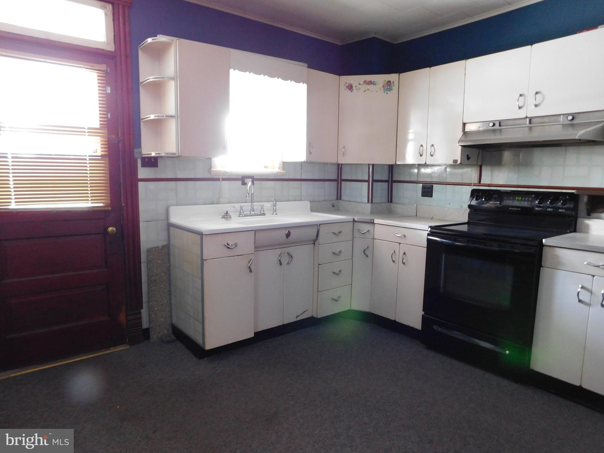 103 East Amidon Street Summit Hill, PA 18250 - Photo 6 of 16 a kitchen with a sink stove and cabinets