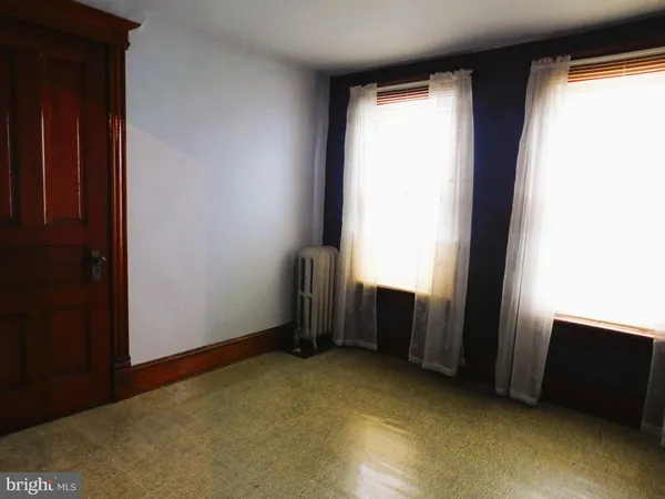a spacious bedroom with a bed and window
