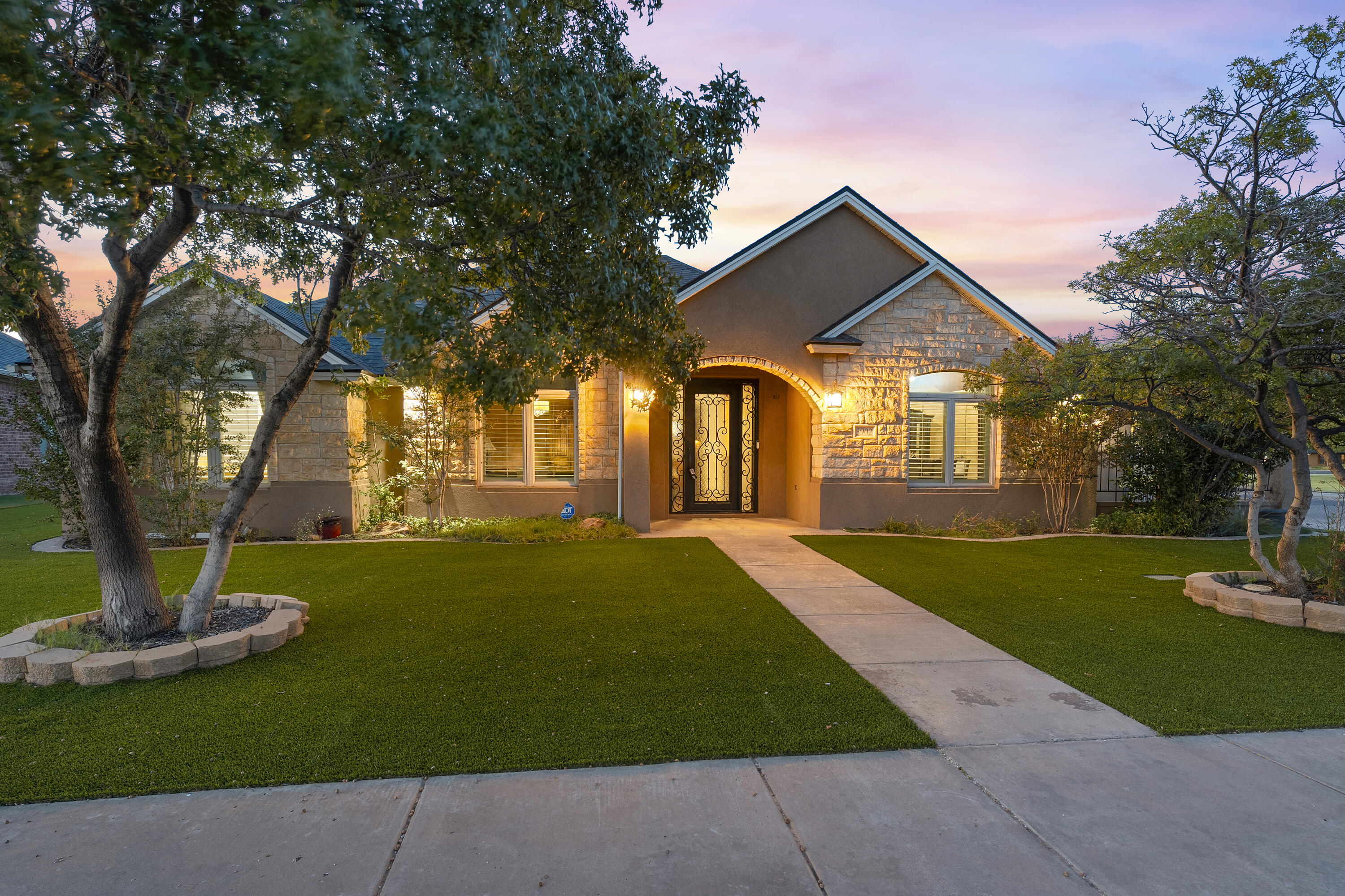 3902 101st Street Lubbock, TX 79423 - Photo 2 of 37 a front view of a house with a yard and trees