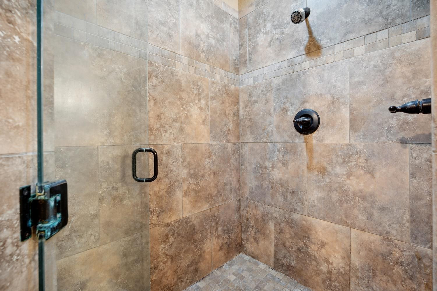 3902 101st Street Lubbock, TX 79423 - Photo 21 of 37 a bathroom shower with a shower