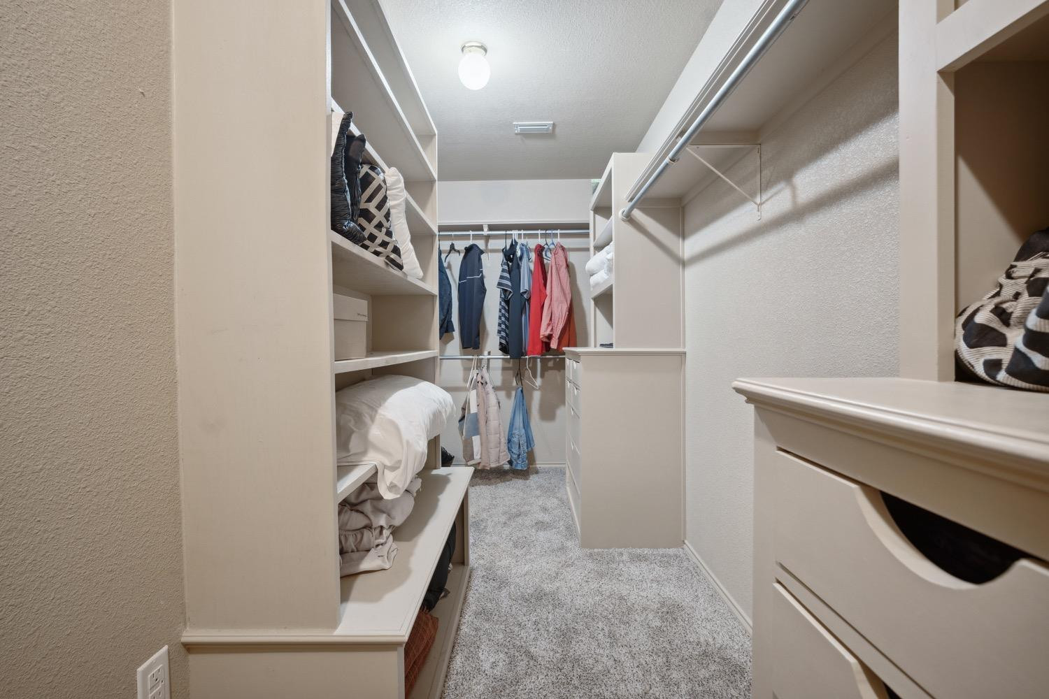 3902 101st Street Lubbock, TX 79423 - Photo 23 of 37 a view of walk in closet with clothes and shoes