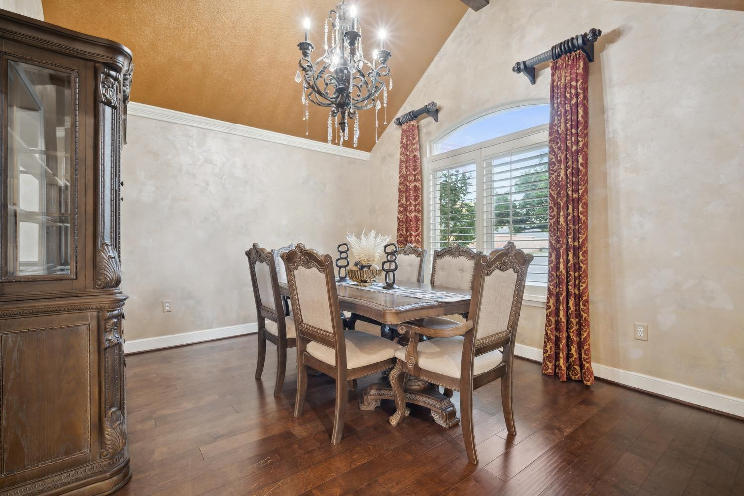 3902 101st Street Lubbock, TX 79423 - Photo 9 of 37 a view of a dining room with furniture wooden floor and chandelier