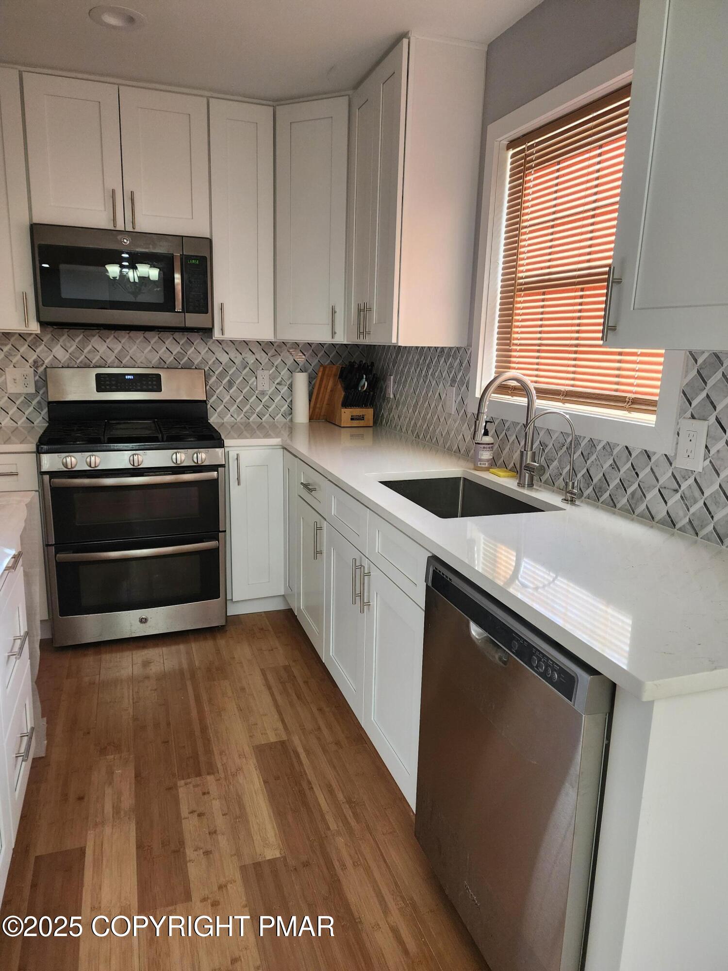 283 Pocono Boulevard Bushkill, PA 18324 - Photo 16 of 44 a kitchen with a sink stove and microwave