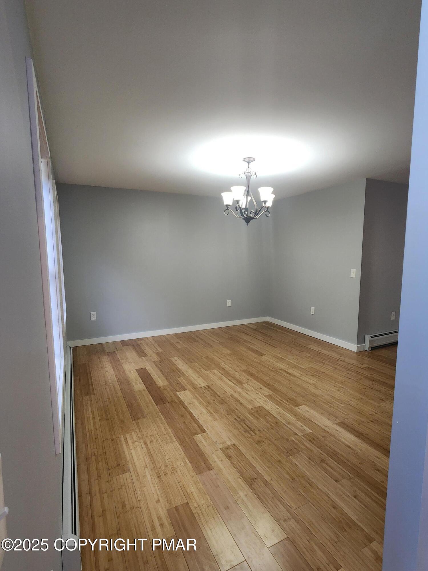 283 Pocono Boulevard Bushkill, PA 18324 - Photo 24 of 44 wooden floor in an empty room with a mirror