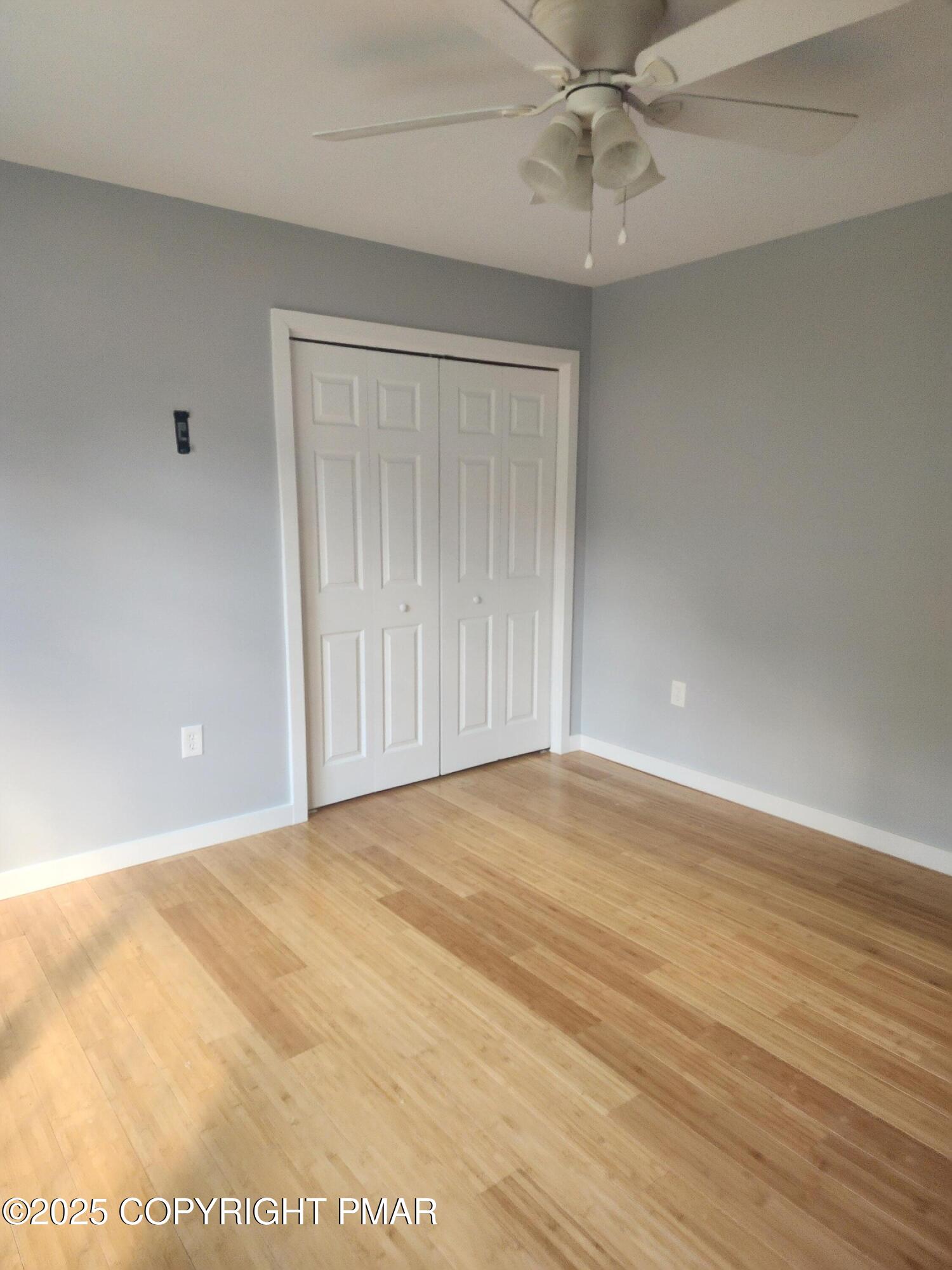 283 Pocono Boulevard Bushkill, PA 18324 - Photo 37 of 44 an empty room with wooden floor and fan