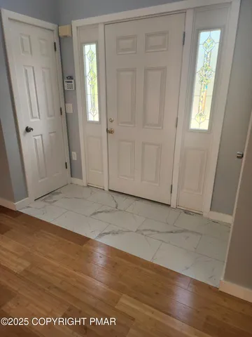 a view of a room with wooden floor