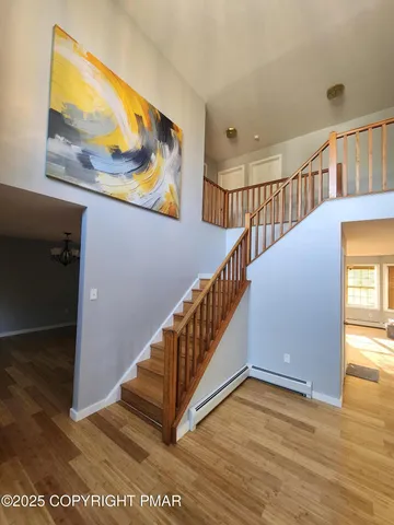 wooden floor in an empty room with a mirror