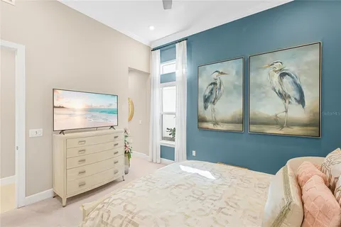 a living room with furniture a window and a flat screen tv