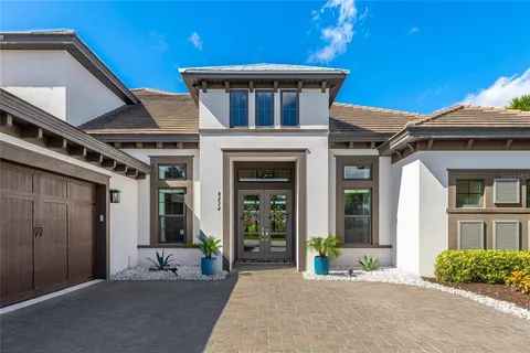 a living room with furniture a fireplace and a potted plant