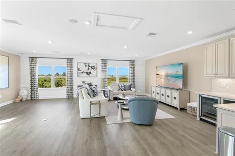 a living room with furniture a rug and white walls
