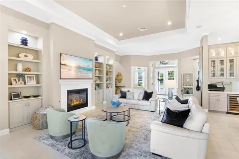 a living room with furniture fireplace and a large window