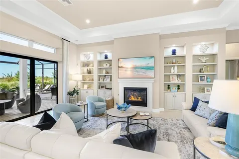 a kitchen with stainless steel appliances kitchen island granite countertop a table chairs and a refrigerator