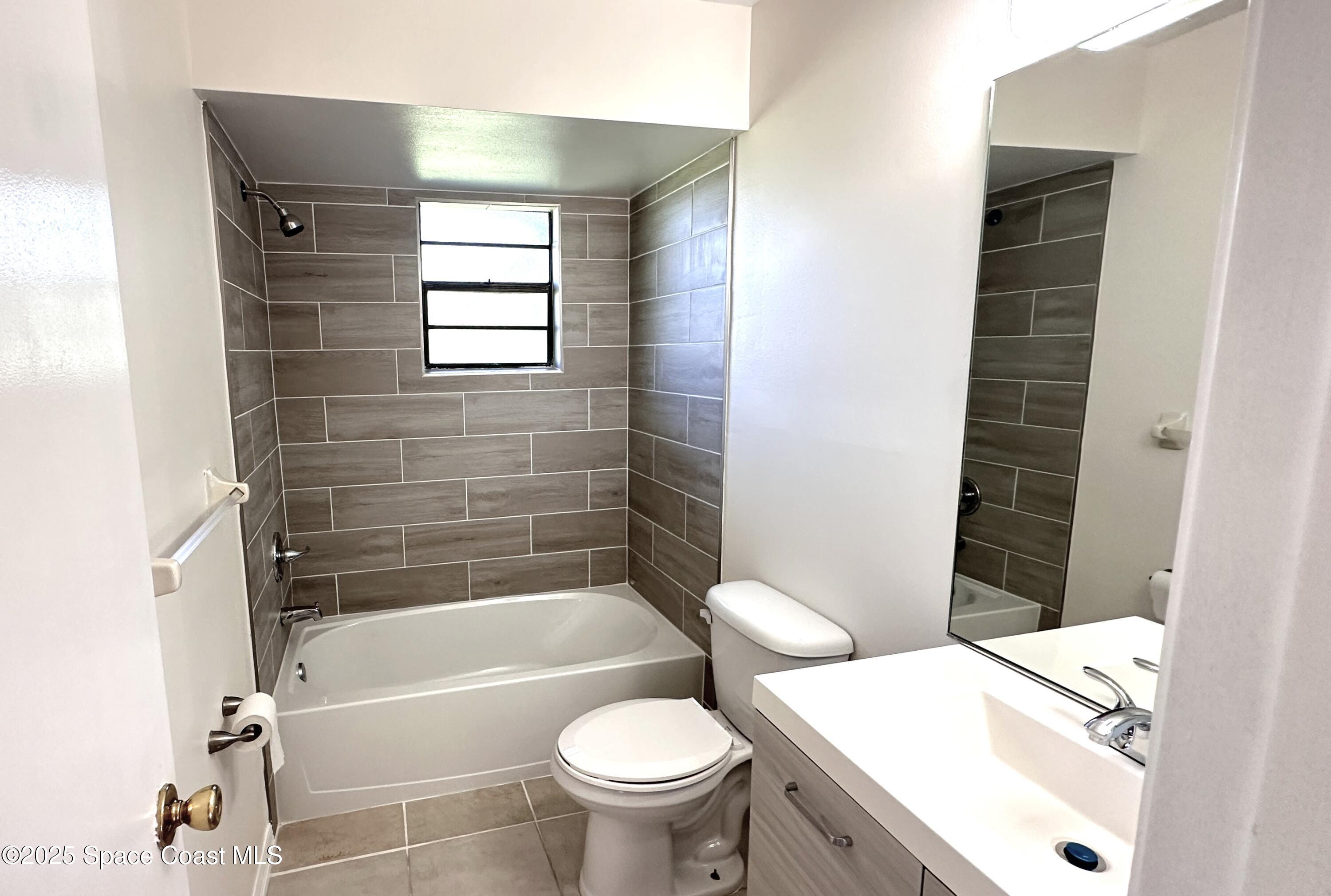 3807 Jupiter Boulevard Southeast Palm Bay, FL 32909 - Photo 11 of 34 a bathroom with a sink toilet and shower