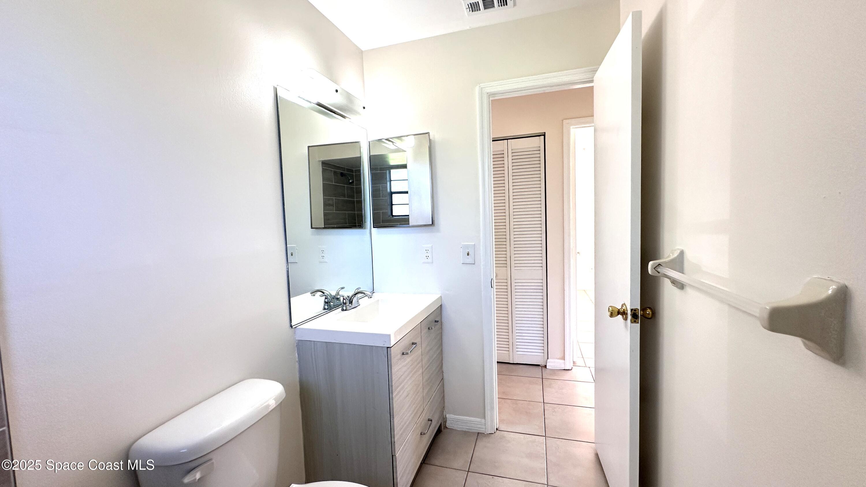 3807 Jupiter Boulevard Southeast Palm Bay, FL 32909 - Photo 12 of 34 a bathroom with a sink a toilet and shower