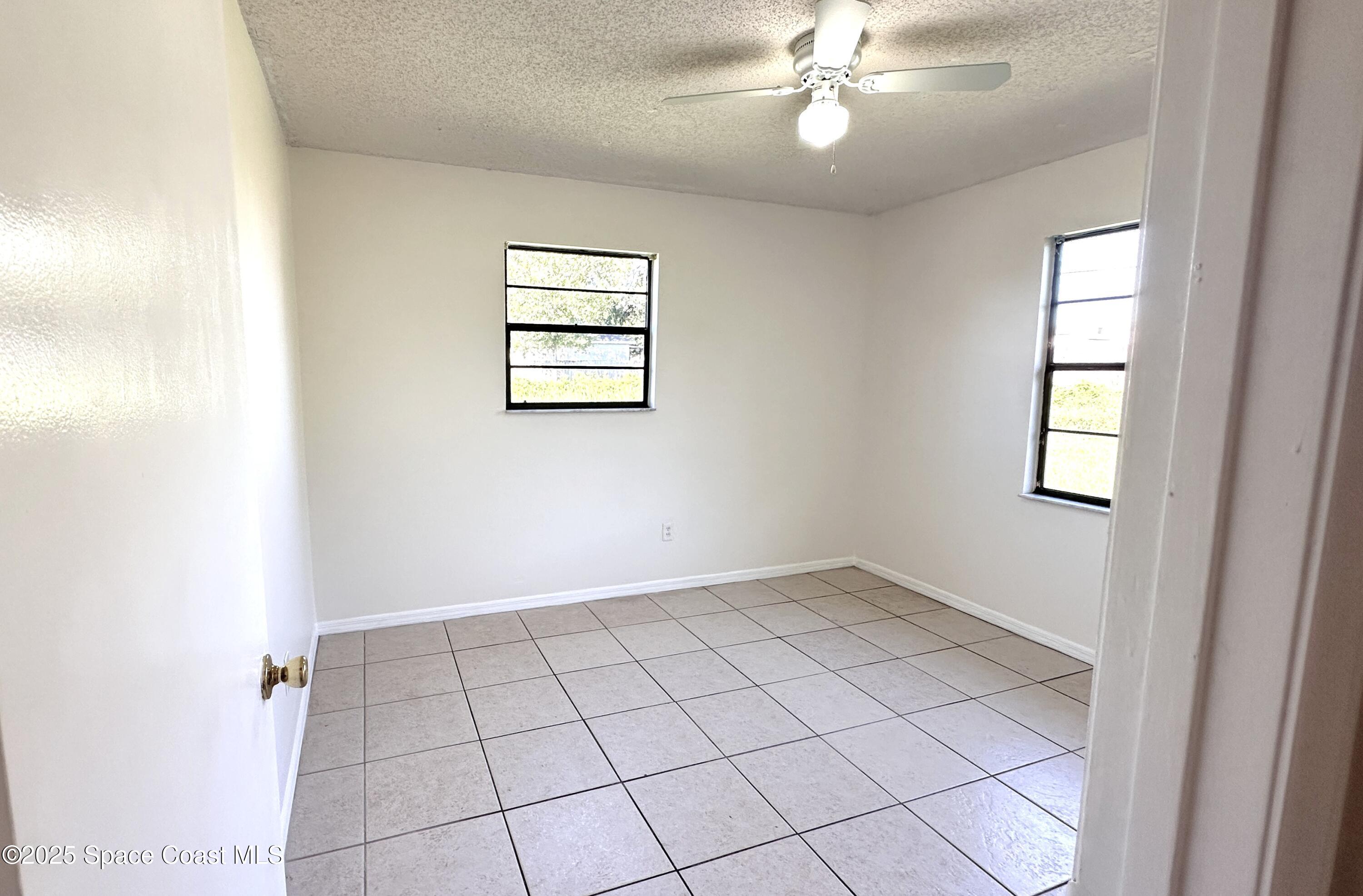 3807 Jupiter Boulevard Southeast Palm Bay, FL 32909 - Photo 13 of 34 a view of an empty room with a window