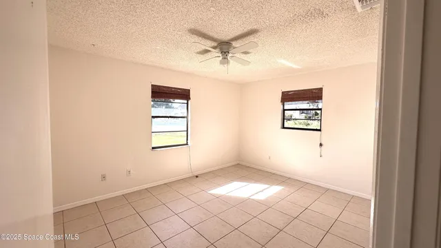 a view of a livingroom with a ceiling fan and window
