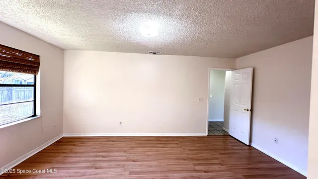 an empty room with wooden floor