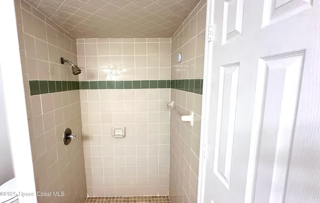 a bathroom with a double vanity sink a mirror and a shower