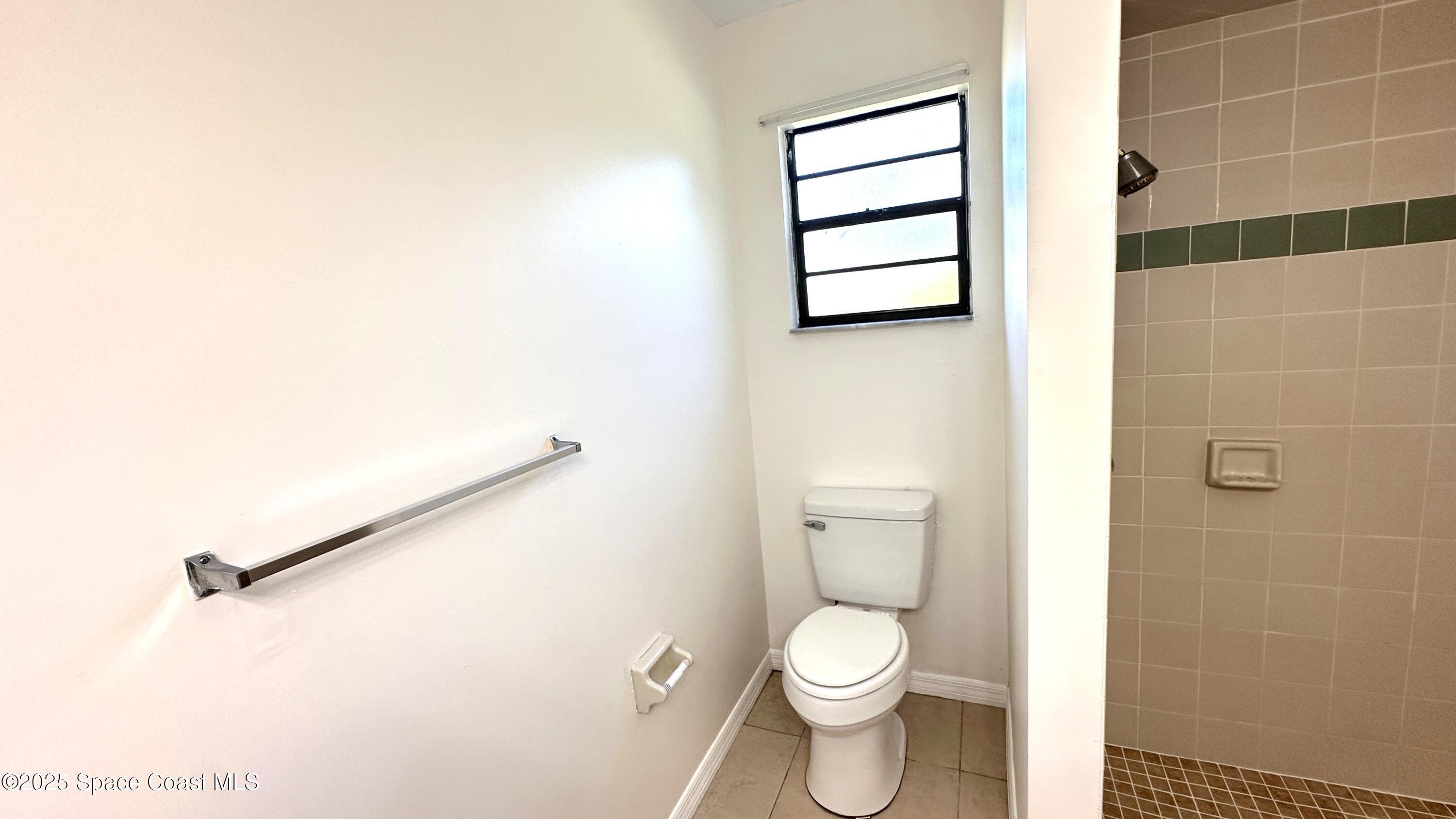 3807 Jupiter Boulevard Southeast Palm Bay, FL 32909 - Photo 29 of 34 a bathroom with a toilet and a shower