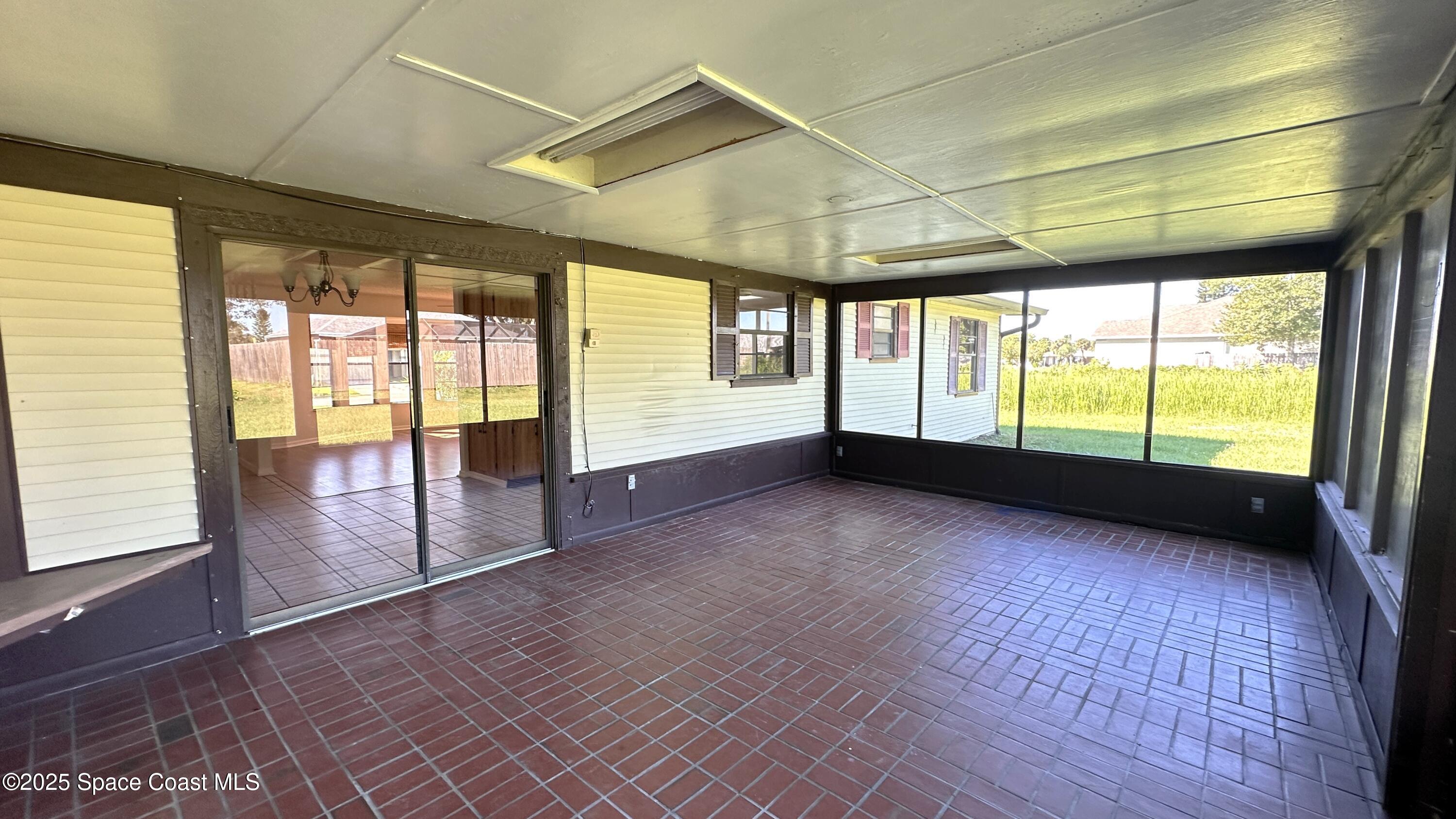 3807 Jupiter Boulevard Southeast Palm Bay, FL 32909 - Photo 32 of 34 a view of an empty room with wooden floor and a window