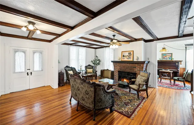 a living room with furniture a fireplace and wooden floor