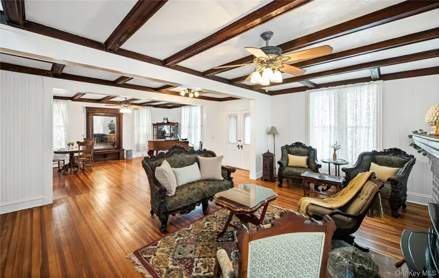 a living room with furniture a ceiling fan and a rug