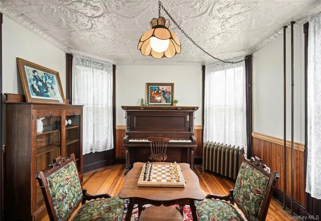 a living room with furniture a table and a painting on the wall