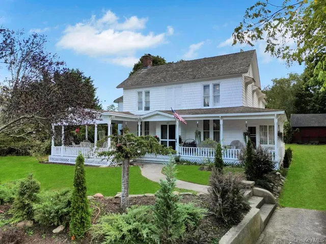 a front view of a house with a yard table and chairs