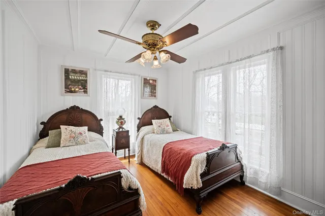 a bedroom with two beds and a chandelier