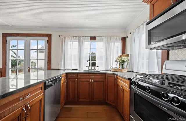 a kitchen with stainless steel appliances a sink stove and cabinets