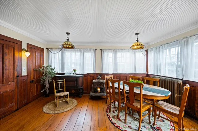 a view of a dining room with furniture window and wooden floor