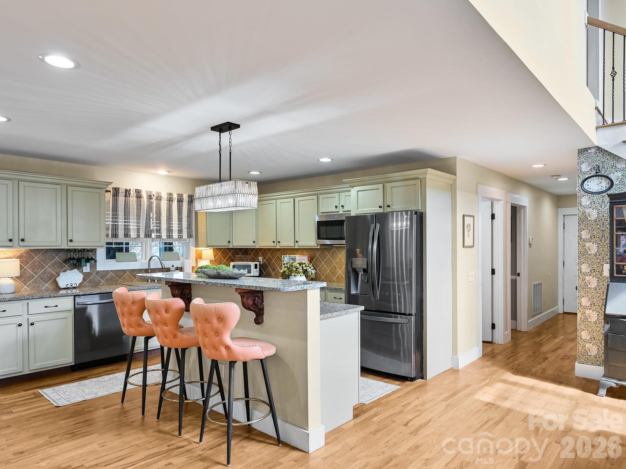 1645 Ivy Hill Road Marshall, NC 28753 - Photo 12 of 36 a kitchen with refrigerator and chairs