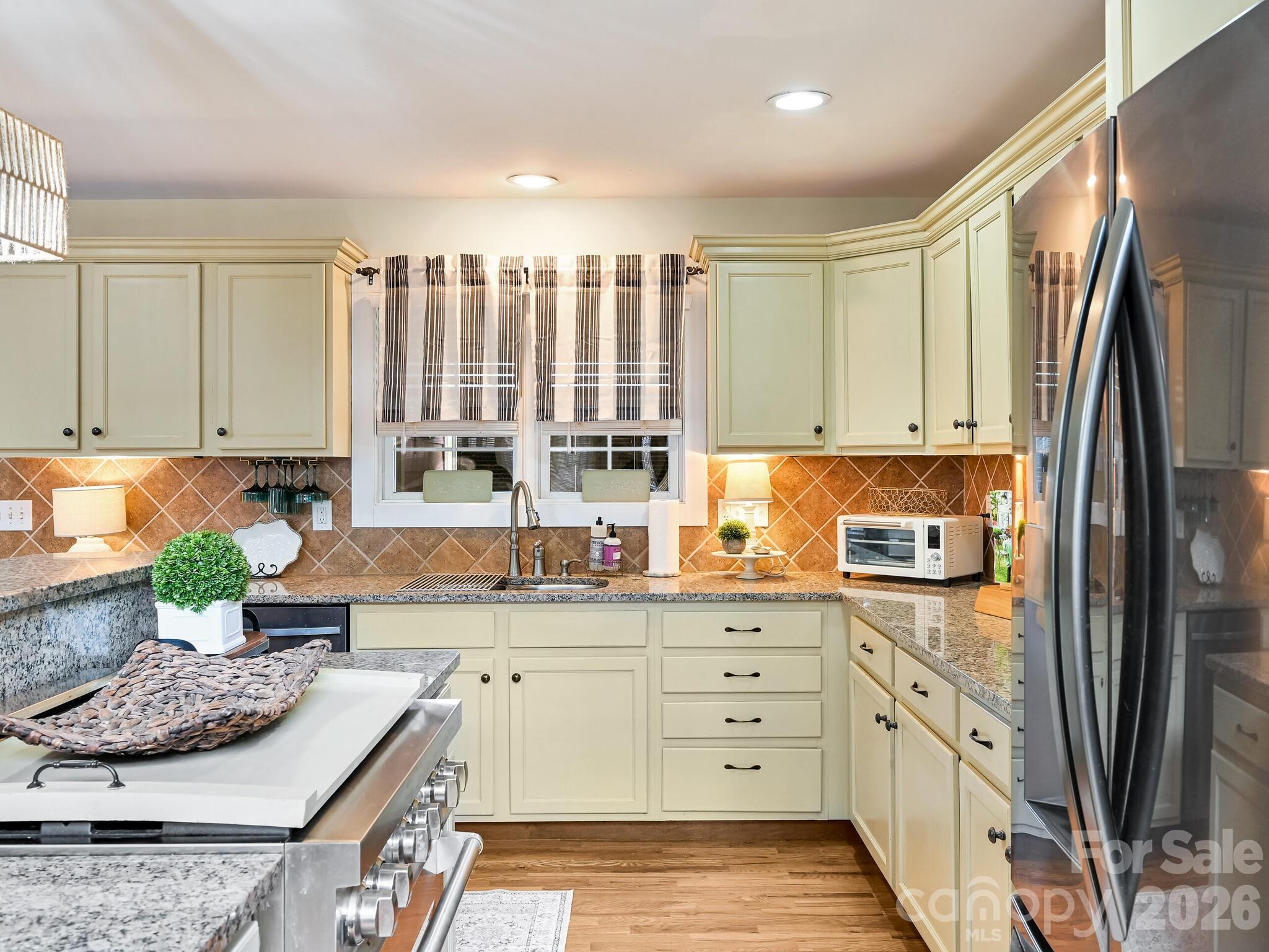 1645 Ivy Hill Road Marshall, NC 28753 - Photo 15 of 36 a kitchen with stainless steel appliances granite countertop a stove a sink and a refrigerator