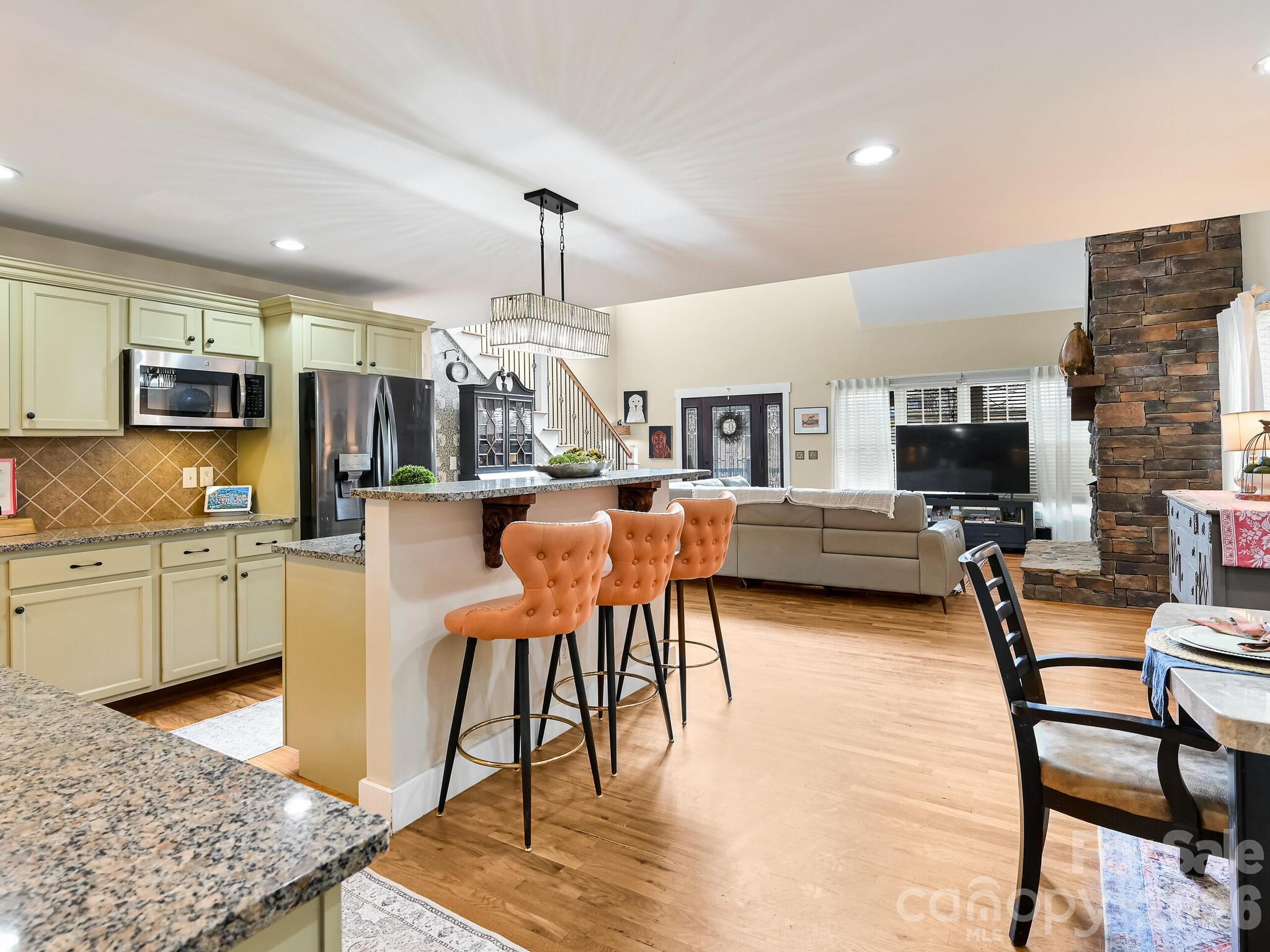 1645 Ivy Hill Road Marshall, NC 28753 - Photo 16 of 36 a living room with furniture a flat screen tv and kitchen view